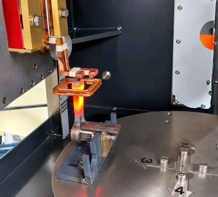 Image of an industrial metal heating application featuring machinery from Induction Annealing Machine Manufacturers in India